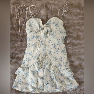 Sundress with adjustable tie straps and bow detail at décolletage. Never worn.